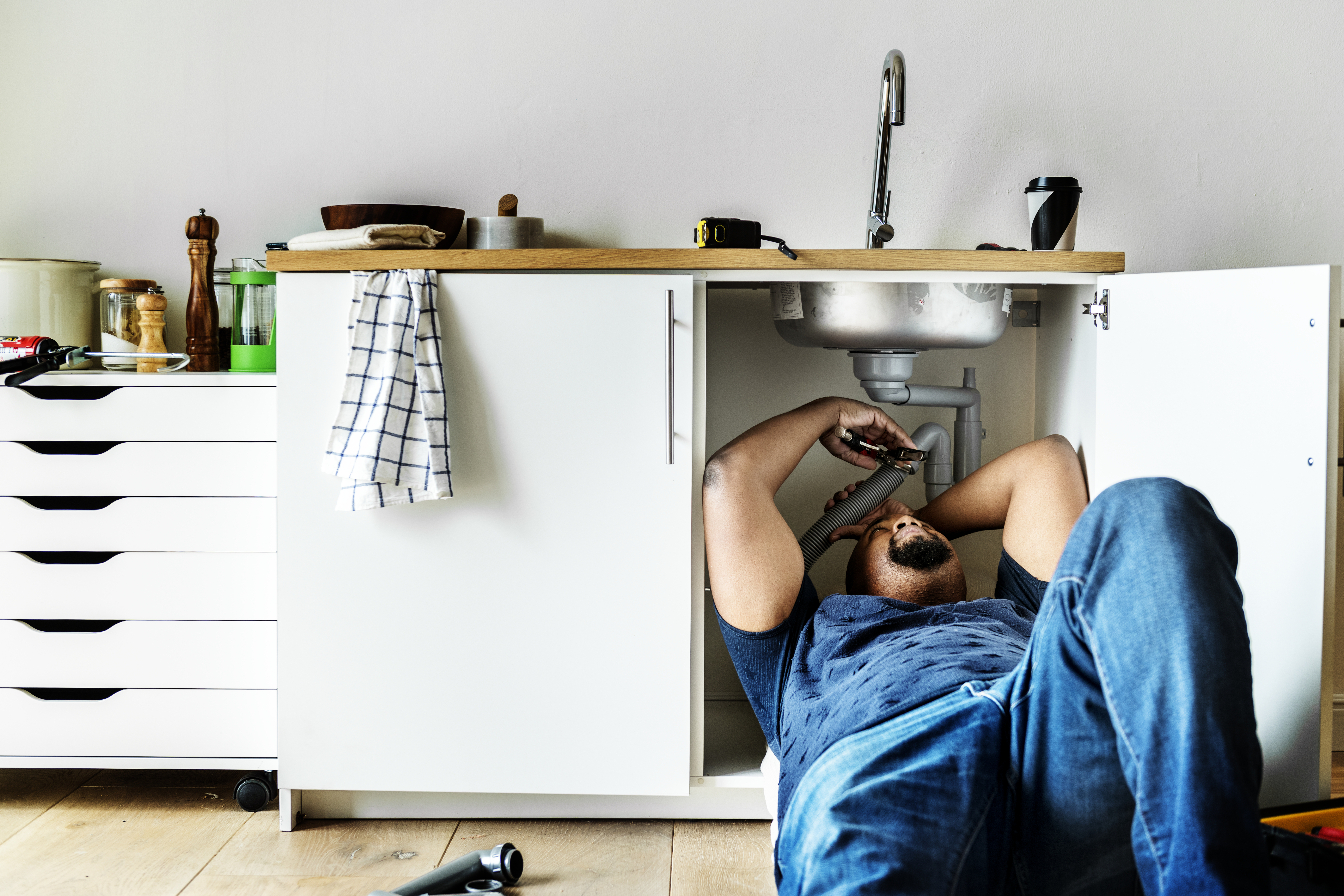 Plumber repairing a kitchen sink
